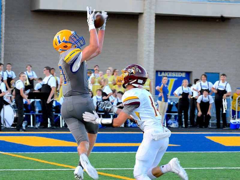 The Sentinel-Record/Grace Brown PASSING GAME: Lakeside's Sawyer Lamb, left, jumps to make a catch Friday against Lake Hamilton's Justin Speer at Lakeside Stadium.