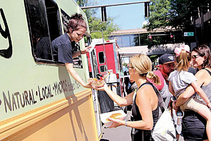 Hungry people fill downtown for the Main Street Food Truck Festival, where 60 food trucks dish up foods to fit every taste. 