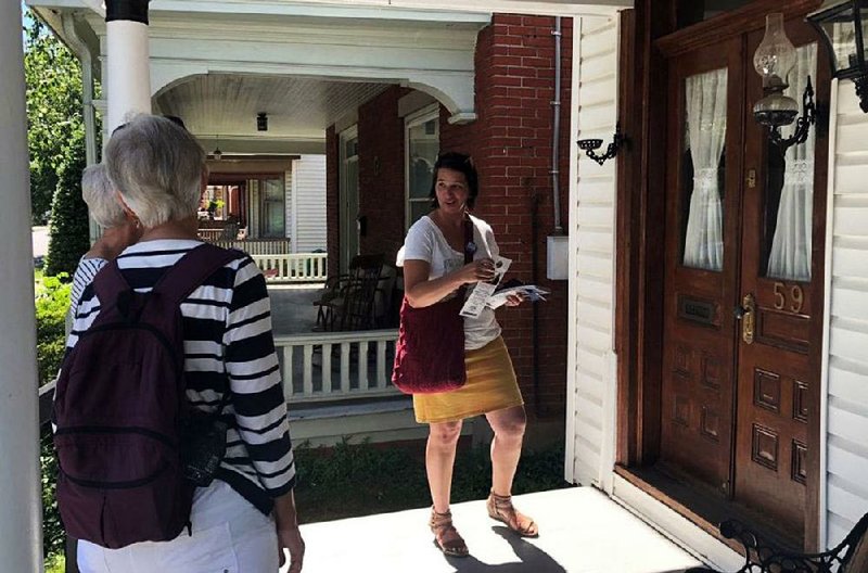 Jess King, candidate for Congress, talks to two of her campaign volunteers as she rings doorbells in Lititz, Pa. 