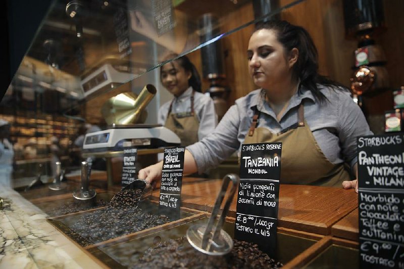 Employees at a Starbucks roastery in Milan, Italy, prepare Thursday for today’s opening day. 