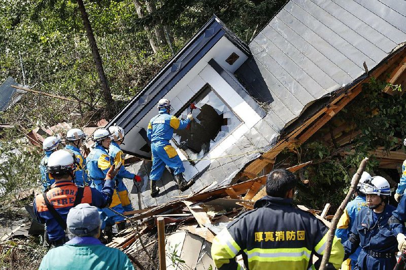 Police search for survivors Thursday at a house destroyed by a landslide in the Japanese town of Atsuma after a powerful earthquake hit the northern island of Hokkaido. 