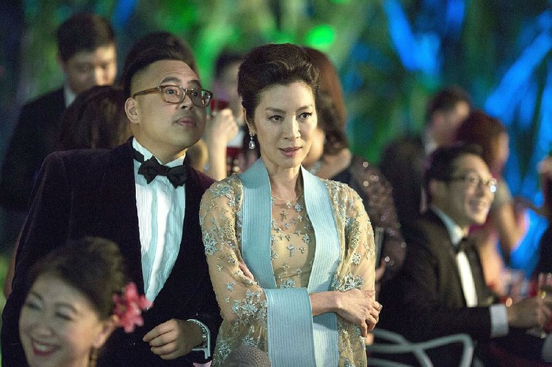 Nico Santos and Michelle Yeoh in a scene from Crazy Rich Asians, a perfectly fi ne romantic comedy that has been hailed as a breakthrough because of its predominantly Asian cast. But is it really worth all the hype?
