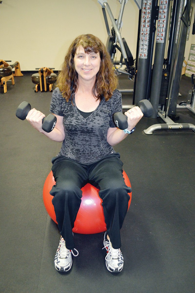 Sherri Lachowsky, health-and-wellness coordinator and personal trainer at the Ola and John Hawks Senior Wellness and Activity Center in Conway, sits on a medicine ball in the facility’s weight room. She teaches several classes for seniors, from Drums Alive to boot camp, and she said studies show social interaction and exercise help seniors stay sharper, mentally and physically.