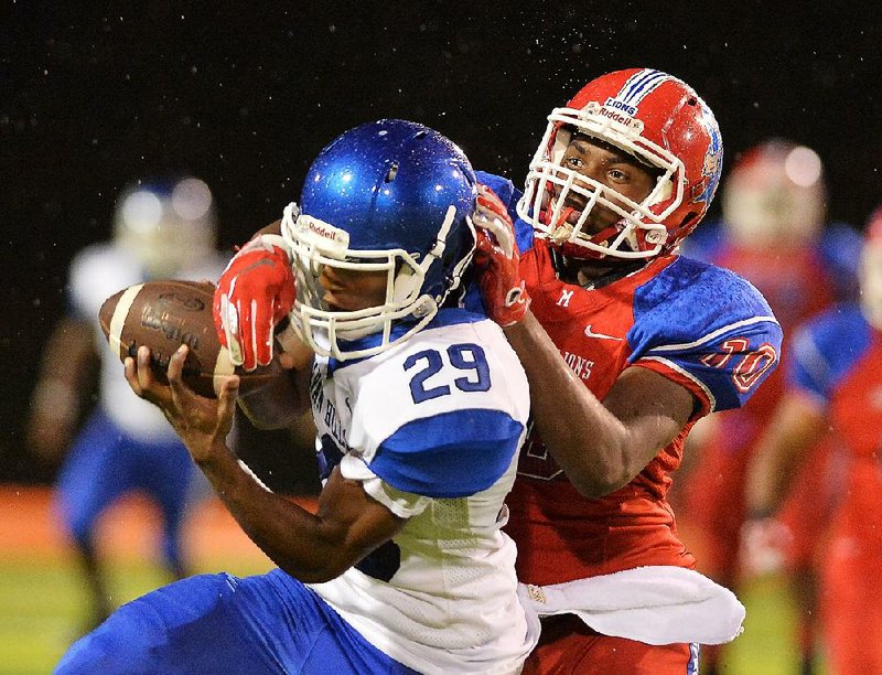 McClellan defender Damion Martin Jr (right) knocks the football away from Sylvan Hills receiver Keith Green during Friday night's game at Scott Field in Little Rock.

Special to the Democrat-Gazette/JIMMY JONES