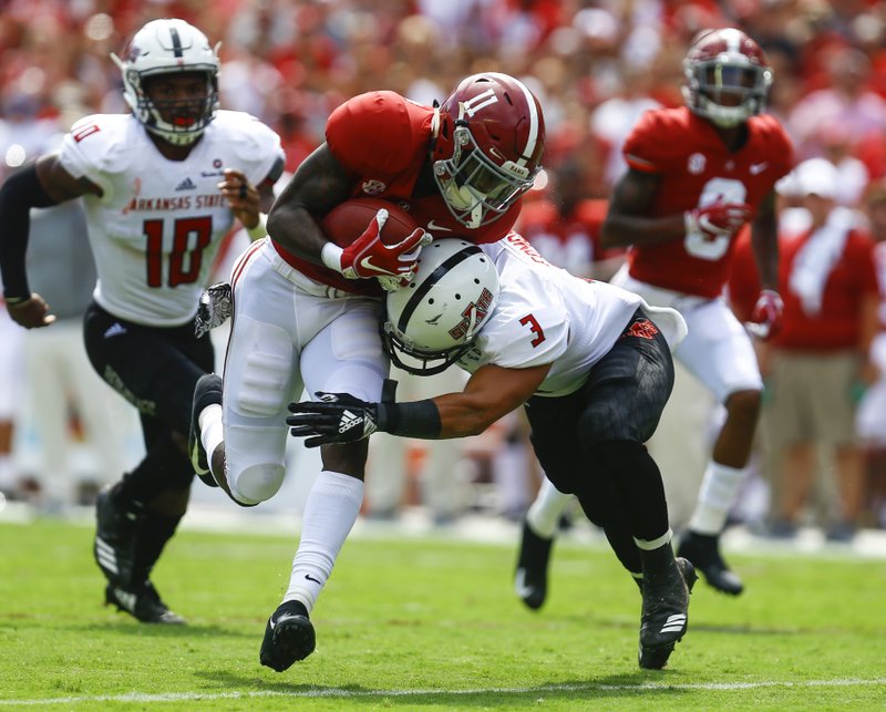 Alabama wide receiver Henry Ruggs III (11) breaks the would be tackle of Arkansas State defensive back B.J. Edmonds (3) and runs for a touchdown during the first half of an NCAA college football game, Saturday, Sept. 8, 2018, in Tuscaloosa, Ala. (AP Photo/Butch Dill)

