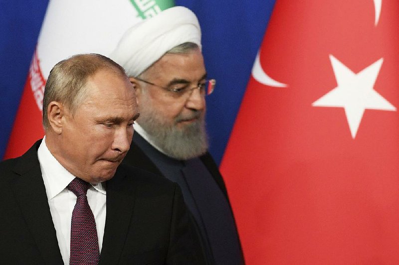 Russian President Vladimir Putin and Iranian President Hassan Rouhani arrive for a news conference Friday in Tehran along with Turkish President Recep Tayyip Erdogan after a trilateral summit on Syria. Using terms like “total annihilation” and “cleansing,” Putin and Rouhani called for a military operation to take the last rebel stronghold, but Erdogan called for a cease-fire.     
