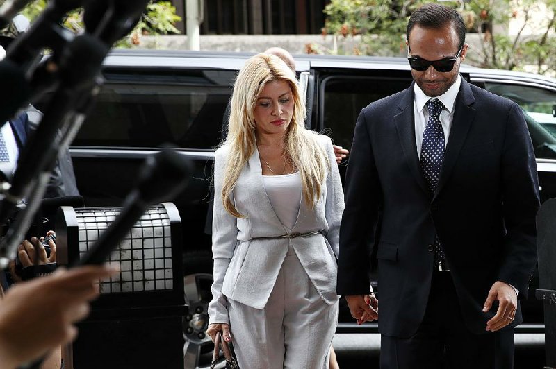 George Papadopoulos and his wife, Simona Mangiante, arrive at federal court Friday in Washington for his sentencing. “I made a dreadful mistake, but I am a good man who is eager for redemption,” Papadopoulos told U.S. District Judge Randolph Moss, who said he was was moved by the defendant’s “genuine remorse about what he did.”