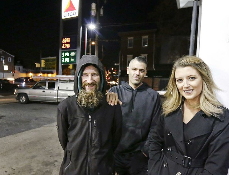 Johnny Bobbitt (left) is pictured last year with Mark D’Amico and Katelyn McClure, who raised money for the homeless Bobbitt after Bobbitt gave McClure money to buy gas. 