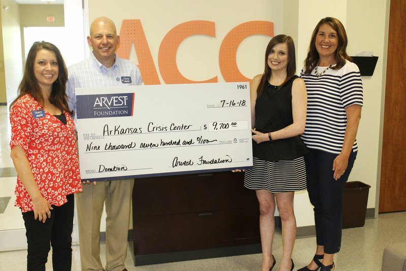 Courtesy photo Arkansas Crisis Center will be able to provide necessary training to their staff thanks to a $9,700 donation from the Arvest Foundation. The gift was announced recently at the Arkansas Crisis Center in Springdale. Stacy Matlock, Chris Thornton and Julie Shook of Arvest Bank were on hand to present the check to Emily Gilbertson. This donation will allow the Arkansas Crisis Center to become certified to train others in ASIST (Applied Suicide Intervention Skills Training).