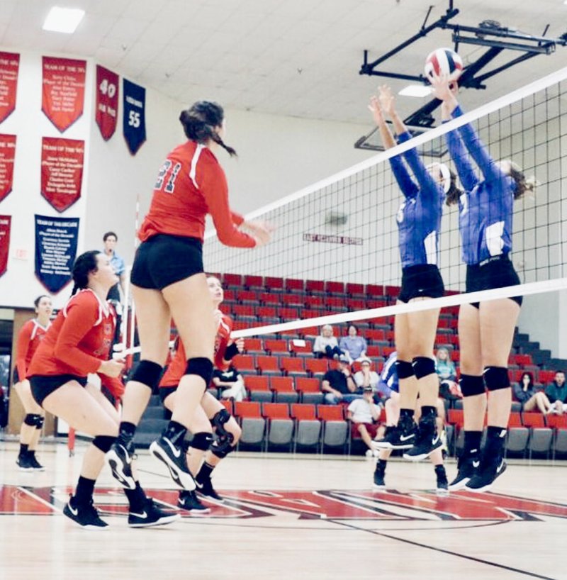 Photo submitted John Brown's Jessica Meyer and Taylor Glover go up for a block during Friday's match at Mid-America Christian. JBU defeated MACU 3-2.