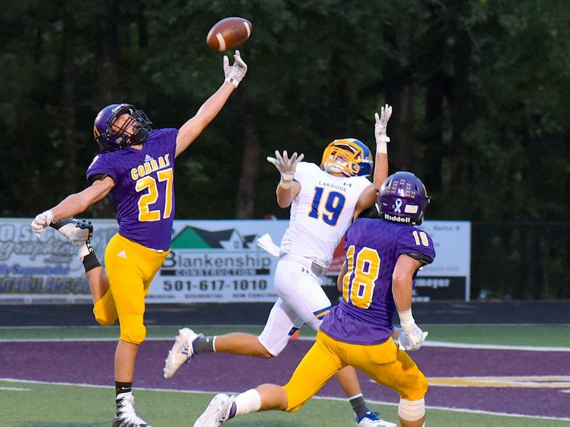 The Sentinel-Record/Jami Smith CATCH DENIED: Fountain Lake sophomore Asa Westerman (27) tips the ball away from Lakeside sophomore Ty Davis (19) as senior Kyle Fortner (18) defends last Friday night at Allen Tillery Field. The Cobras defeated the Rams, 40-27.