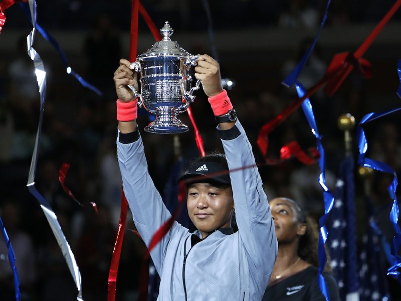 Naomi Osaka, of Japan, holds the trophy after defeating Serena Williams in the women's final of the U.S. Open tennis tournament, Saturday, Sept. 8, 2018, in New York. (AP Photo/Adam Hunger) 