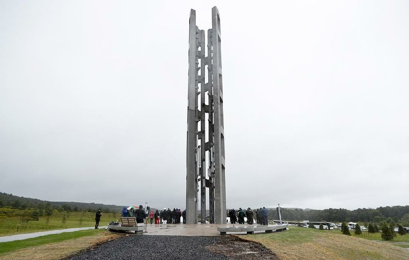 People attend the dedication of the 93-foot tall Tower of Voices on Sunday at the Flight 93 National Memorial in Shanksville, Pa. The tower contains 40 wind chimes representing the 40 people who perished in the crash of Flight 93 in the terrorist attacks of Sept. 11, 2001.