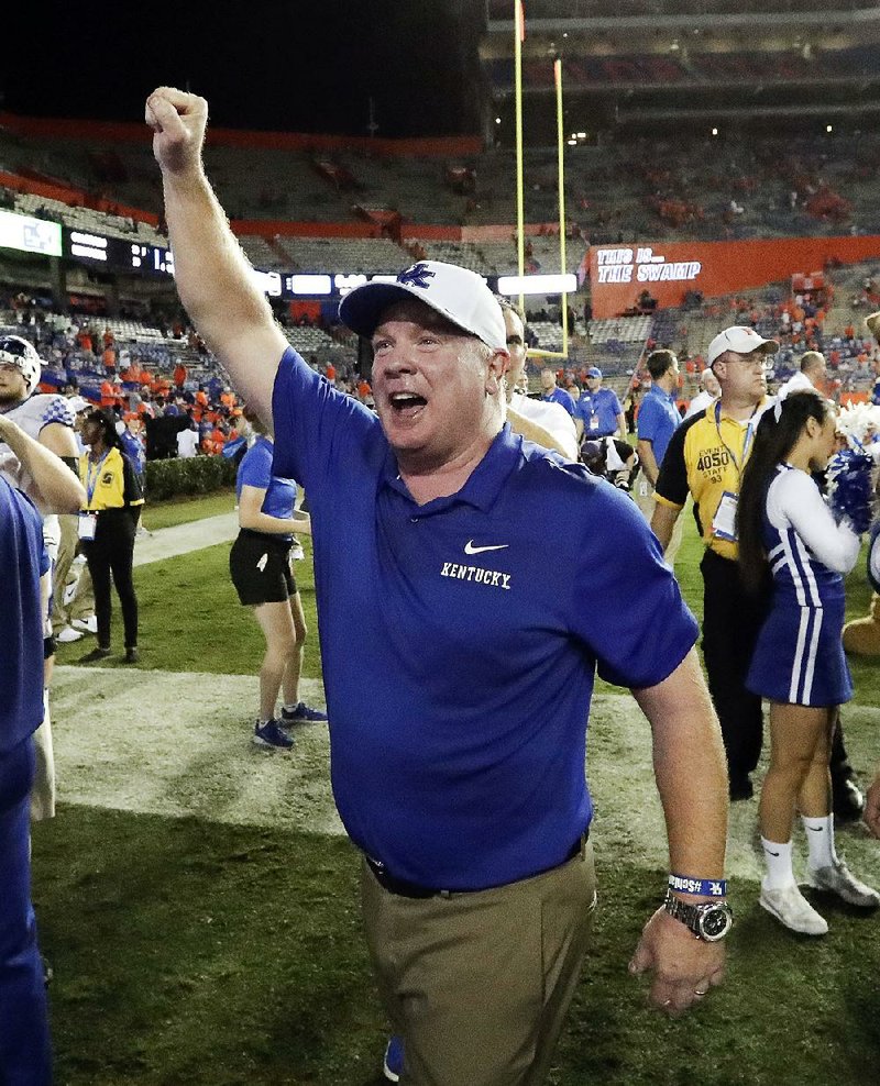 Kentucky head Coach Mark Stoops celebrates with fans after the Wildcats defeated Florida 27-16 for their first victory over the Gators since 1986. 