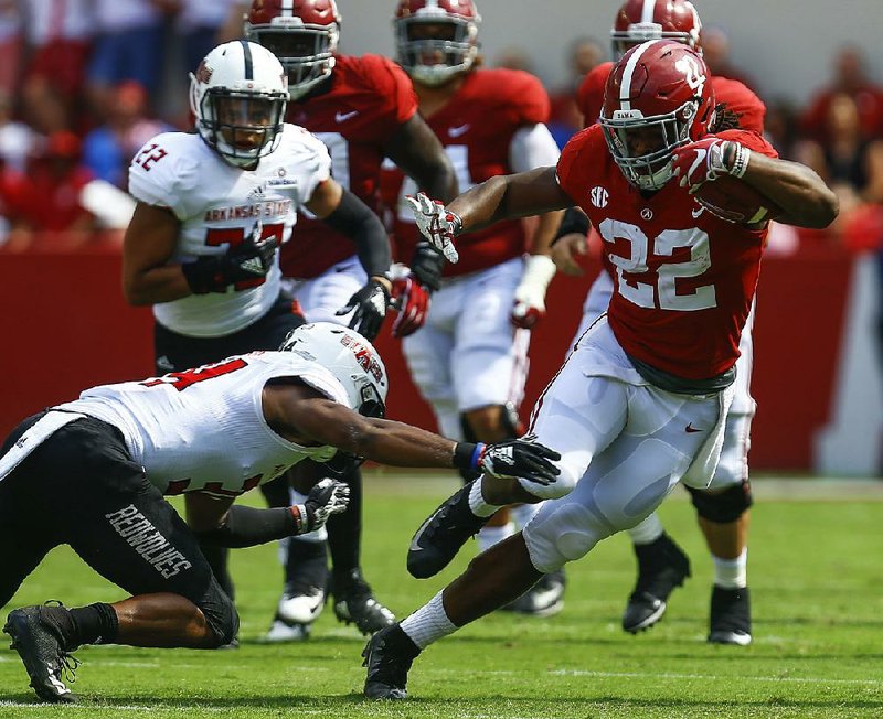 Alabama running back Najee Harris (22) avoids a tackle attempt by Arkansas State’s Darreon Jackson during Saturday’s game. Harris rushed for 135 yards and 1 touchdown on 13 carries. 