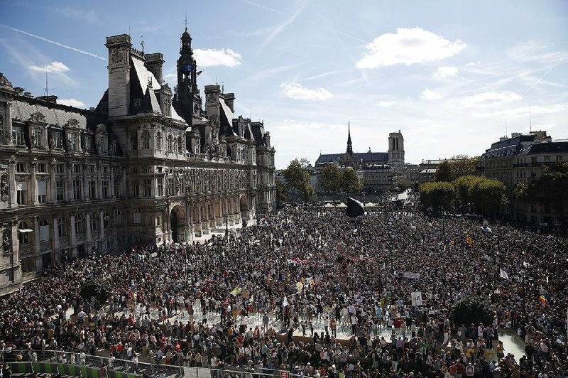 Thousands of people gather in Paris for Saturday’s march supporting measures to combat climate change.  