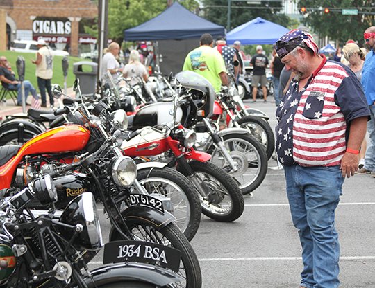 Marvin Gibson, of Louisiana, views the antique motorcyles in Hill Wheatley Plaza on Saturday, September 8. (The Sentinel-Record/Rebekah Hedges)