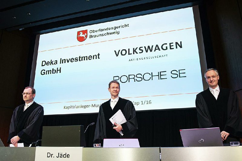 Judges Nicolai Stephan (from left), Christian Jaede and Friedrich Hoffmann arrive at court Monday in Braunschweig, Germany, for the opening of a lawsuit against Volkswagen brought by sharehold- ers who lost money in the diesel emissions scandal.