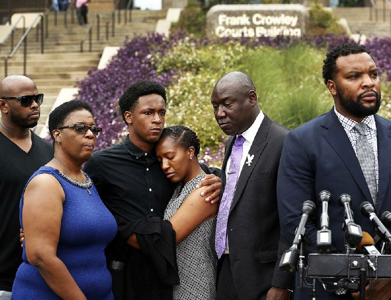 Allison Jean (second from left), mother of shooting victim Botham Jean; Brandt Jean, the victim’s brother; and his sister Allisa Charles-Findley attend a news conference outside the Frank Crowley Courts Building on Monday in Dallas, about the shooting of Botham Jean by Dallas police officer Amber Guyger on Thursday.