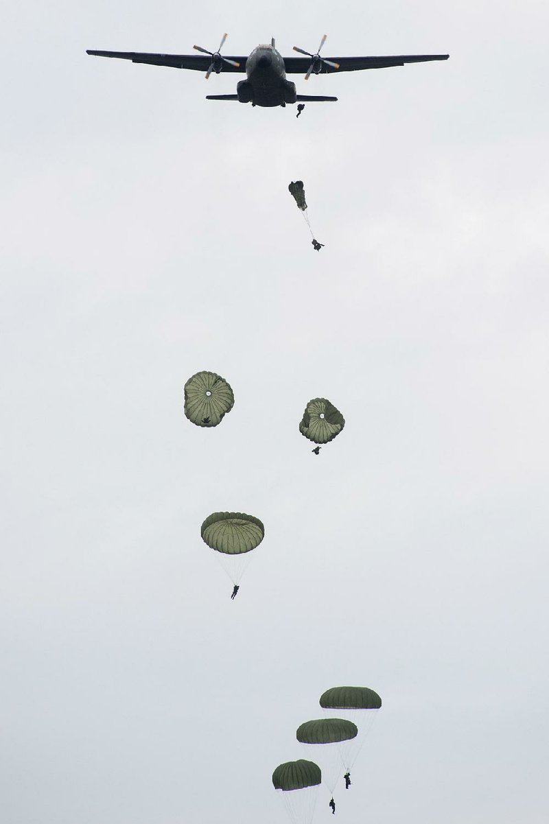 The German army’s fast forces jump from an aircraft during a maneuver in Borstel, eastern Germany, on Monday.