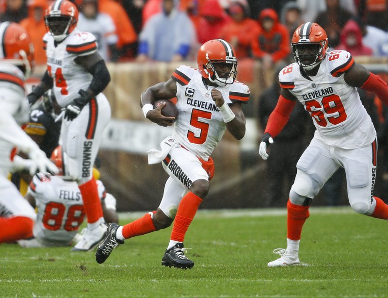 The Associated Press TIE TAYLOR: Browns quarterback Tyrod Taylor (5) runs against the Pittsburgh Steelers during the first half of a 21-21 tie Sunday in Cleveland.