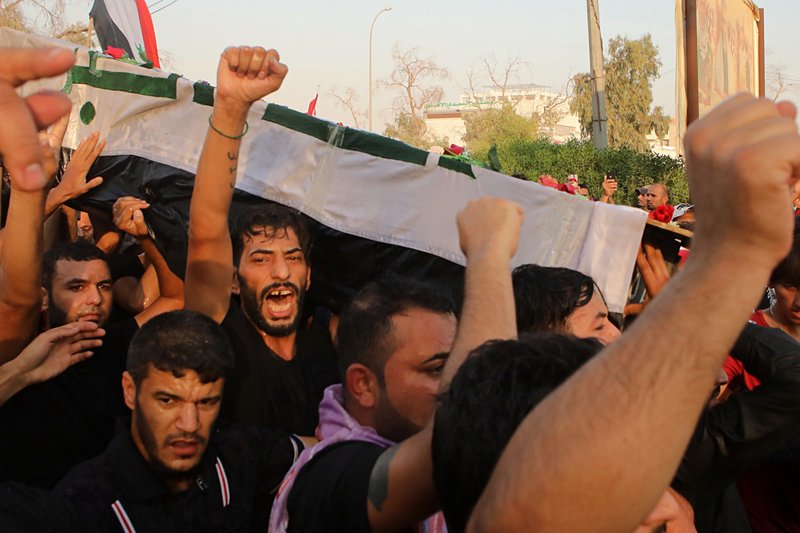 FILE - In this Friday, Sept. 7, 2018 file photo, mourners chant anti government slogans while carrying the coffin of Abdul Salam Fathi, a protester whose family said he was killed in a protest, during his funeral in Basra, Iraq. With brackish water pouring from the taps, failing city services and soaring unemployment, the southern Iraqi city of Basra has seen weeks of violent protests in the streets of the country's oil-exporting capital. (AP Photo/Nabil al-Jurani, File)