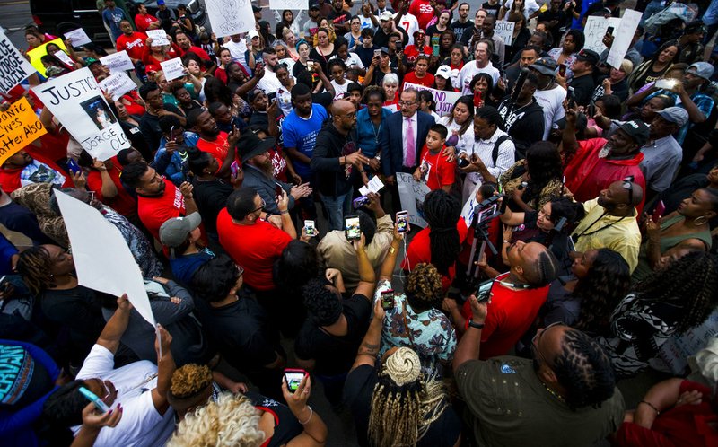 Protesters in the shooting death of Botham Jean, gather at the Jack Evans Police Headquarters, Monday, Sept. 10, 2018, in Dallas.