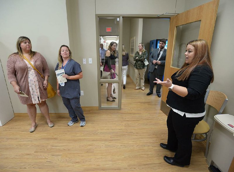 NWA Democrat-Gazette/ANDY SHUPE
Charity Tisdale (right), assistant chief of environmental management services for Veterans Health Care System of the Ozarks in Fayetteville, leads a tour Tuesday, Sept. 11, 2018, of a dayroom after a dedication ceremony for the Leroy Pond Residential Treatment Facility in Fayetteville. The facility offers 20 beds 20-beds and inpatient care for veterans who are facing substance abuse and co-occurring mental illness and homelessness.