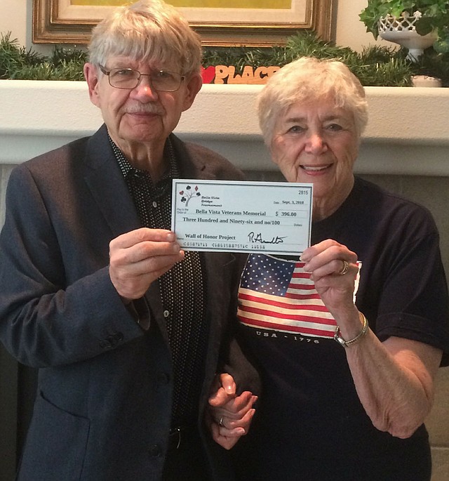 Photo submitted Robert Gromatka, tournament chairman, presents a check for $396 to Julie Storm, a member of Northwest Arkansas Veterans Council. The money was raised during the three-day Bella Vista NLM Bridge Tournament.