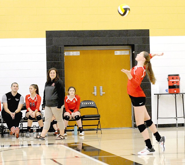 TIMES photograph by Mark Humphrey Lady Blackhawks volleyball coach Jessica Woods watches a serve during Thursday's match at Prairie Grove won by the Lady Blackhawks in three straight sets.