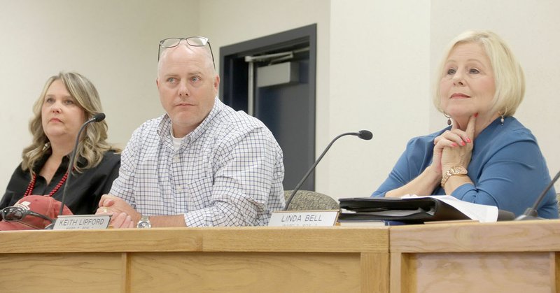 LYNN KUTTER ENTERPRISE-LEADER Farmington City Council members Sherry Mathews, left, Keith Lipford and Linda Bell listen as members of the public address them about a resolution to increase the mayor's salary to $72,000.