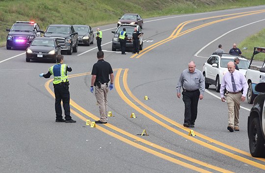 The Sentinel-Record/Richard Rasmussen CRIME SCENE: Hot Springs police detectives work the scene of a reported shooting early Tuesday on Carpenter Dam Road near Lake Park Drive in which a local woman, 37, was injured. Police said they are investigating the incident as a case of domestic violence and a local man, Nelson Green Johnson III, 37, was arrested for violation of a protection order.