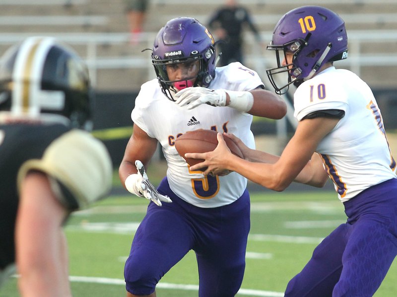 The Sentinel-Record/Richard Rasmussen TAKING OFF: Fountain Lake's Andrew Roberson (5) takes a handoff from quarterback Ian Lacy (10) against Hot Springs on Aug. 30 at Tommy J. Holt Field at Joe Reece Stadium. Roberson tallied 124 yards on 32 carries in the game with two touchdowns.