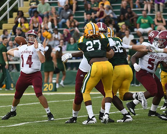 Submitted photo PLAYER OF THE WEEK: Henderson State junior quarterback Richard Stammetti (14) completes a pass Saturday during the Reddies' 38-31 overtime victory on the road against Arkansas Tech in Russellville. Photo by Hunter Lively, courtesy of Henderson State Athletic Communications.