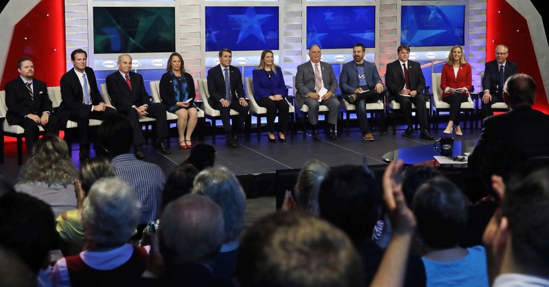 FILE - In this Wednesday, Sept. 5, 2018, file photo, Democratic hopefuls are introduced during a televised debate for New Hampshire's 1st Congressional District at the Institute of Politics at St. Anselm College in Manchester, N.H. From left are William Martin, Deaglan McEachren, Mark MacKenzie, Mindi Messmer, Chris Pappas, Naomi Andrews, Lincoln Soldati, Paul Cardinal, Terence O'Rourke, Maura Sullivan and Levi Sanders. Eleven Democrats and six Republicans are competing in the Tuesday, Sept. 11 primary for a chance to replace Democratic U.S. Rep. Carol Shea-Porter, who is not seeking re-election. (AP Photo/Charles Krupa, Pool, File)