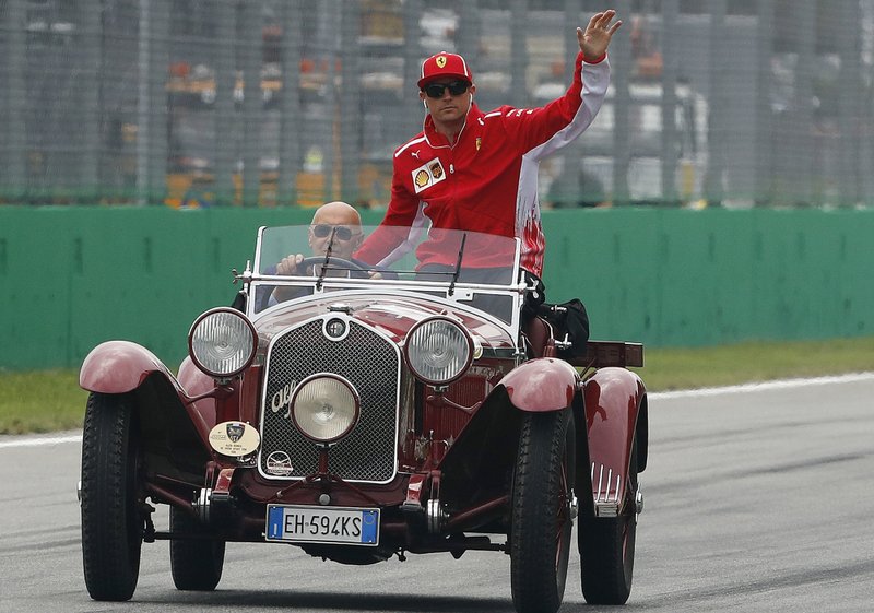 In this Sept. 2, 2018 file photo, Ferrari driver Kimi Raikkonen of Finland waves from an historical Alfa Romeo during the driver parade before the race of the Formula One Italy Grand Prix at the Monza racetrack, in Monza, Italy, Sunday Sept. 2, 2018. 
