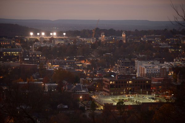 The sun sets over downtown Fayetteville and the University of Arkansas on Nov. 16, 2017.
