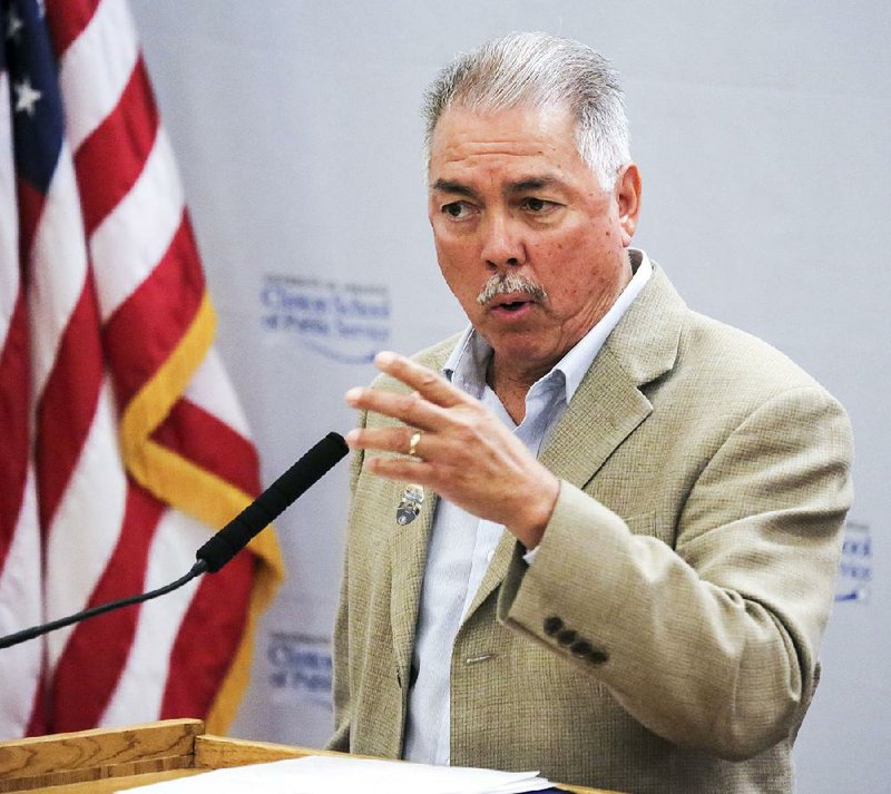 Alan Armijo of Albuquerque, N.M., speaks Wednesday at the University of Arkansas Clinton School of Public Service about a program in his city that pays homeless people cash to help clean up the city or do other jobs.
