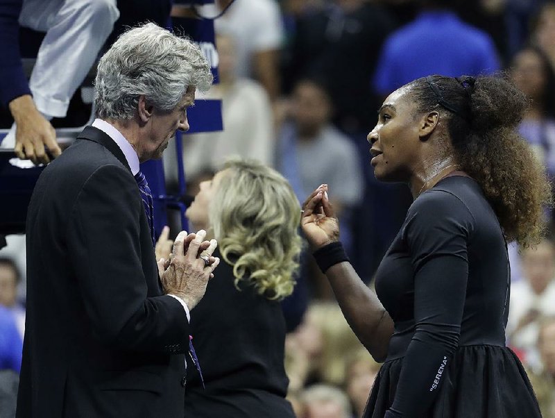 Serena Williams questions referee Brian Earley after an outburst Saturday in the U.S. Open women’s final against Naomi Osaka. The Herald Sun newspaper is defending a cartoon by Mark Knight and his depiction of Williams’ outburst. 