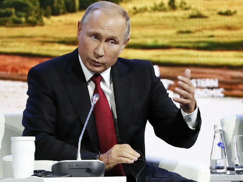 Russian President Vladimir Putin speaks during a meeting at the Eastern Economic Forum in Vladivostok, Russia on Wednesday. Putin says Russia has identified the two men that Britain named as suspects in the poisoning of a former Russian spy. 
