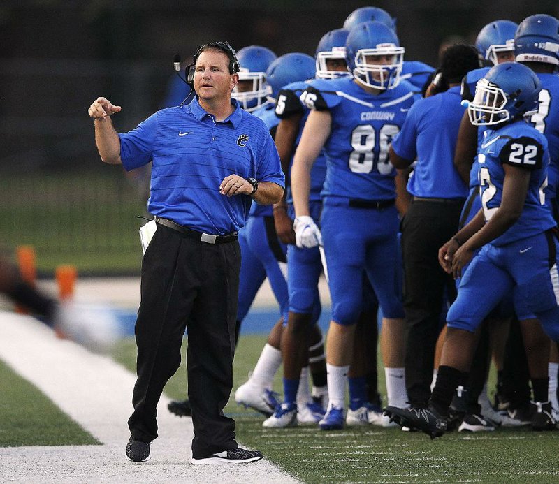 Conway Coach Keith Fimple (left) and the Wampus Cats are 3-0 this season, having come from behind to win their first two games and never trailing against Jonesboro. 