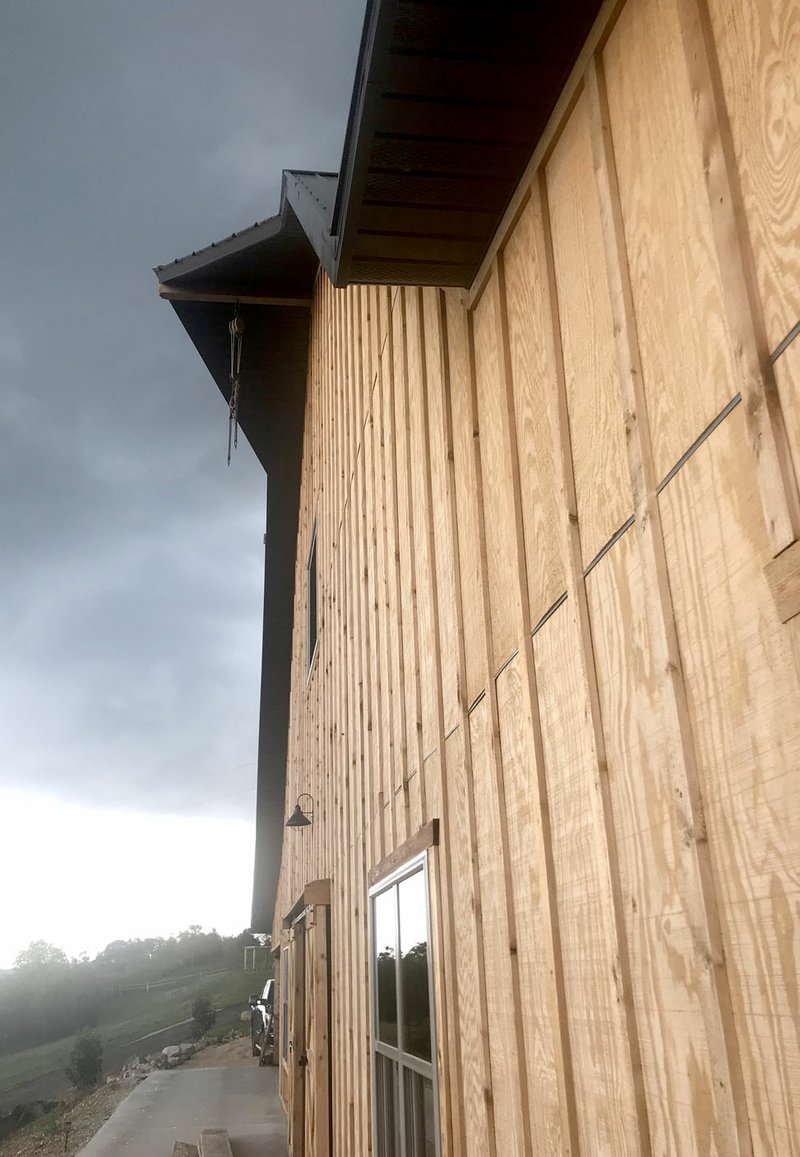 Photo by Sally Carroll/McDonald County Press The Under the Woods barn was designed by Janet Underwood and built by a construction crew from Grove, Okla. The construction company owner, Nathan Miller, gave her the hay hook to hang from the front of the barn.