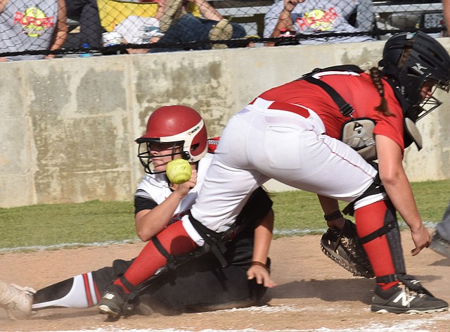 Rick Peck/Special to McDonald County Press McDonald County's Whitney Kinser scores a run on a squeeze bunt by Alexa Hopkins during the Lady Mustangs' 10-0 win over Aurora on Sept. 6 at MCHS.