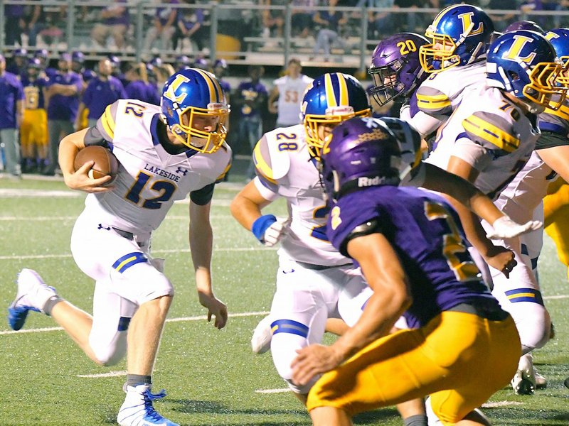 The Sentinel-Record/Grace Brown RAM RECOVERY: Lakeside quarterback Taylor Gillham (12) charges into the end zone Friday during the Rams' 40-27 loss at Fountain Lake.