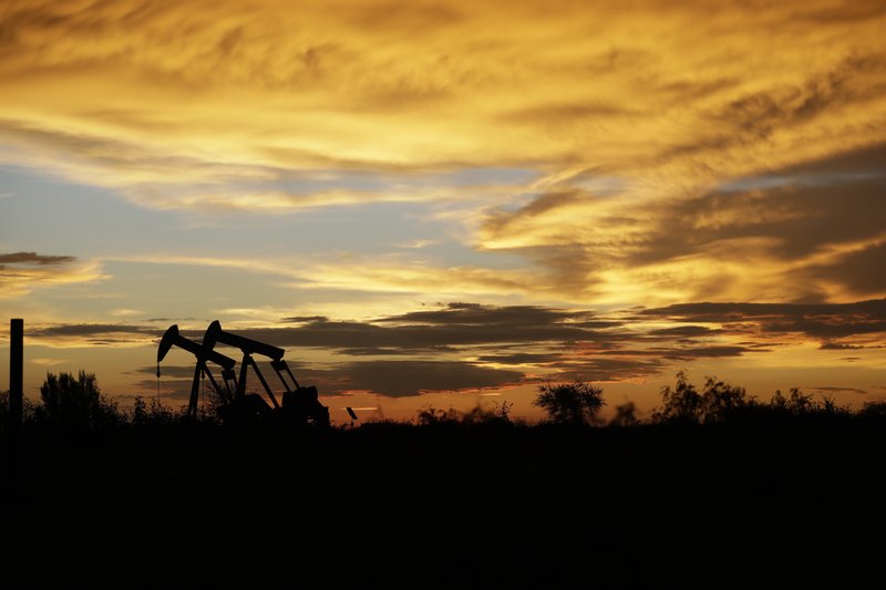FILE- In this June 5, 2017, file photo pumpjacks work in an oil field at sunset after a thunderstorm passed through the area in Karnes City, Texas. The United States may have reclaimed the title of the world's biggest oil producer sooner than expected. The U.S. Energy Information Administration said Wednesday that America &quot;likely surpassed&quot; Russia in June and August after jumping over Saudi Arabia earlier this year. (AP Photo/Eric Gay, File)
