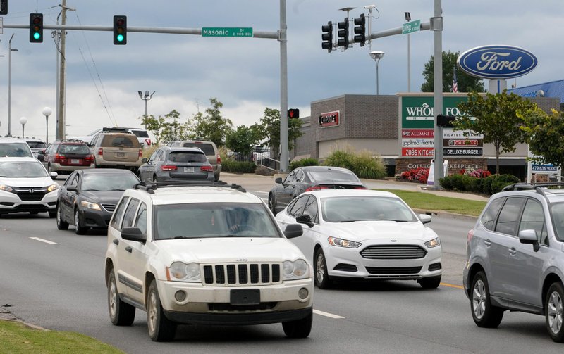 NWA Arkansas Democrat-Gazette/DAVID GOTTSCHALK Traffic moves Wednesday through the intersection of College Avenue and Masonic Drive in Fayetteville. The city is developing a plan to guide development along stretches of College Avenue, Archibald Yell Boulevard and South School Avenue.