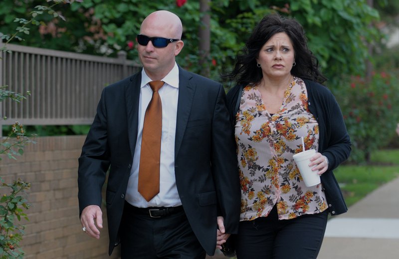 Former state representative Micah Neal (left) walks Thursday, September 13, 2018, with his wife Cindy to the John Paul Hammerschmidt Federal Building in Fayetteville. Neal was to be sentenced for conspiracy to commit fraud in kickback scheme involving state General Improvement Fund grants.
