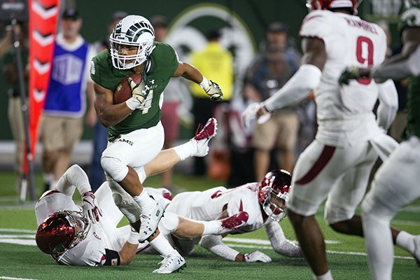 Colorado State running back Izzy Matthews breaks away from Arkansas defenders in the second half of an NCAA college football game Saturday, Sept. 8, 2018, in Fort Collins, Colo. Colorado State won 34-27. (Austin Humphreys/The Coloradoan via AP)

