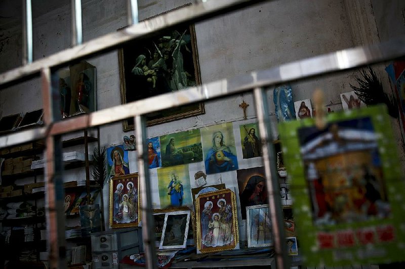 Catholic religious paintings and Bibles are displayed behind bars at an underground Catholic church in Jiexi county in south China’s Guangdong province. A group that monitors Christianity in China says the government is increasing its crackdown on congregations in Beijing and several Chinese provinces, destroying crosses, burning Bibles and ordering followers to sign papers renouncing their faith. 