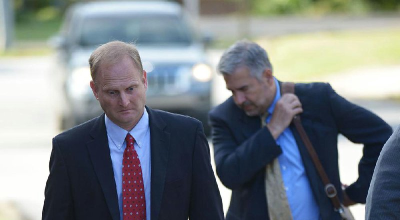 FILE — Oren Paris III (left) heads to federal court on Sept. 12 in Fayetteville to be sentenced for his part in a kickback scheme involving the college he headed. 